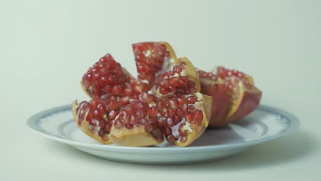 Pomegranate-open-showing-delicious-red-seeds,-Rack-focus