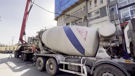tilt-down-to-concrete-truck-in-usage-at-a-high-rise-site-in-addis-ababa-ethiopia