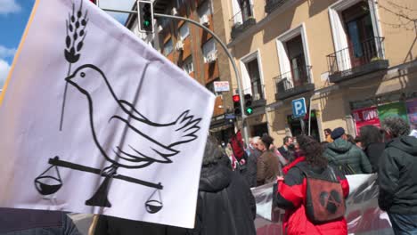 A-protestor-holds-a-placard-with-a-drawing-depicting-a-dove-of-peace-during-a-demonstration-against-the-Ukraine-war-and-NATO's-'imperialist-expansionism'-role-in-Madrid,-Spain