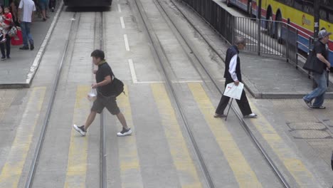 Slow-motion-of-pedestrian-crossing-street-in-train-bus-stop-station-in-downtown