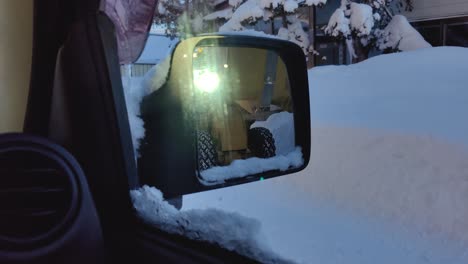 View-Of-CAT-903B-Wheel-Loader-Removing-Snow-In-Front-Wing-Mirror-Of-Car-And-Driving-Past