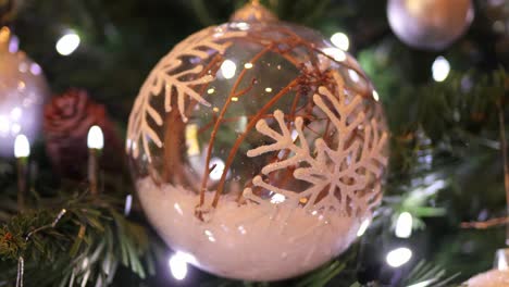 decorated-glass-christmas-tree-ball-with-lights-reflections-and-fake-snow-inside