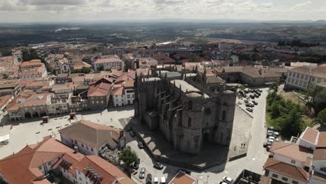 Establishing-shot-of-castle-like-cathedral-in-Guarda-Portuguese-tourism-location,-panoramic-drone-view
