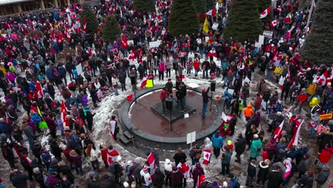 Crowd-with-speaker-pull-out-from-above-wide-Calgary-Protest-12th-Feb-2022