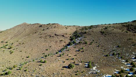 Aerial-view-over-desert-landscape-in-Mount-Washington-Nevada,-sunny