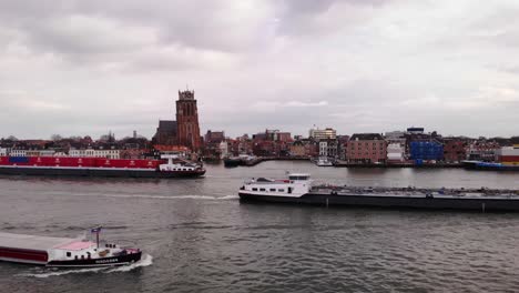 Aerial-Flying-Over-Oude-Maas-As-Three-Ships-Pass-Each-Other-With-Our-Lady-of-Dordrecht-In-Background