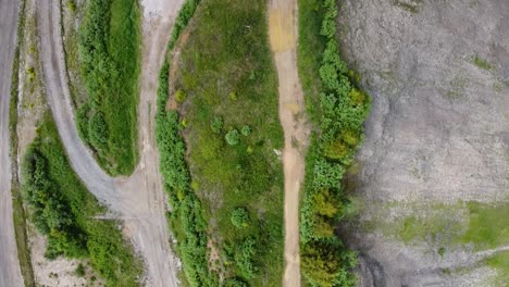 Drone-shot-of-a-Hiking-Path-along-a-Ridge-with-Vegetation-and-Rock