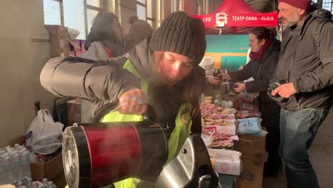 Providing-hot-drinks-and-snacks-to-aid-workers,-refugees,-police-and-soldiers-at-the-train-station-in-Lviv,-Ukraine