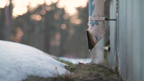 Water-dripping-from-an-old-drain-pipe