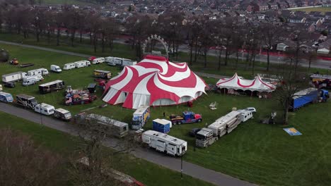 Planet-circus-daredevil-entertainment-colourful-swirl-tent-and-caravan-trailer-ring-aerial-view-pull-away-zoom-out
