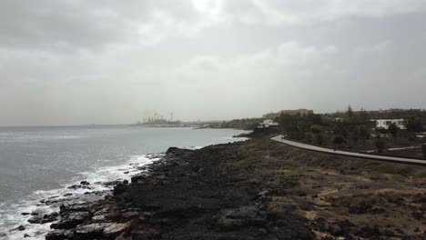 Cinematic-drone-shot-flying-over-coastal-path-on-Lanzarote-island