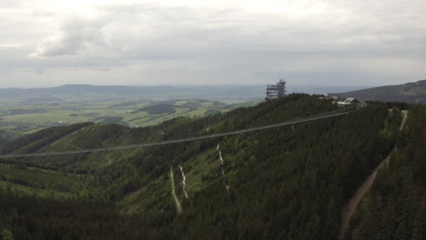 World's-longest-suspension-footbridge-in-Dolní-Morava-mountains,-drone