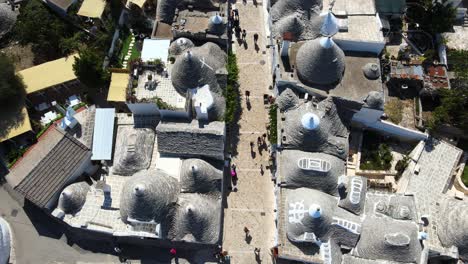 Aerial-drone-top-shot-of-small-walking-streets-around-Alberobello,-Italy
