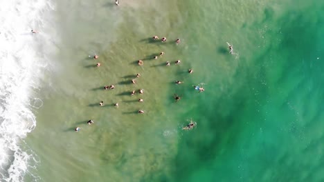 Drone-Rotating-Shot-of-People-inside-Sea-in-Summer-Brazil,-Florianopolis