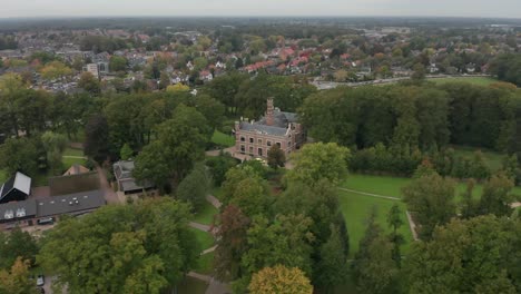 Cinematic-aerial-of-a-beautiful-old-mansion-on-green-estate