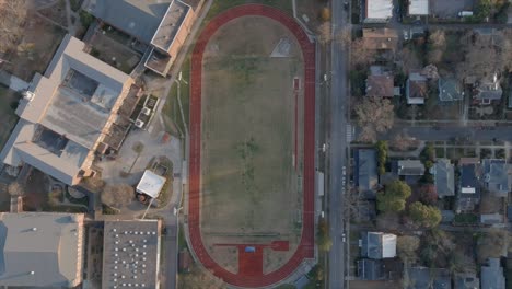 Aerial-top-down-view-over-Durham-football-field-and-track-in-Noth-Carolina,-USA