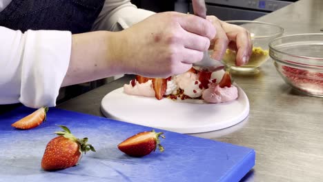 Pouring-rose-petals-above-a-strawberry-dessert