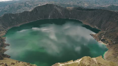 Quilotoa-Volcanic-Crater-Lagoon-With-Turquoise-Waters-In-Ecuador---aerial-drone-shot