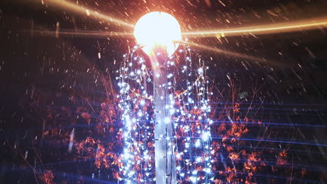 Snow-falling-around-lamppost-and-holiday-lights,-light-beams-glow-brightly