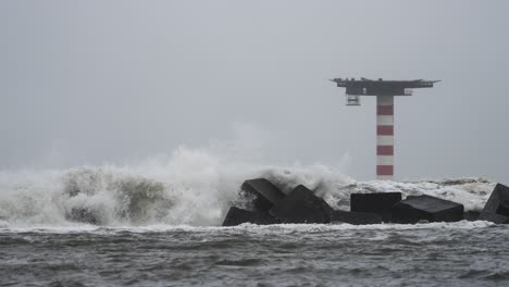 A-stationary-footage-of-huge-waves-of-water-due-to-extremely-bad-weather-while-hitting-the-breakwater-structure-that-were-constructed-to-protect-against-tides,-currents,-waves,-and-storm-surges