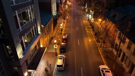 Man-runs-on-city-street-sidewalk-at-night