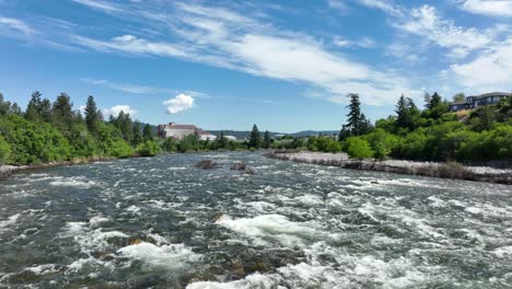 Wide-aerial-shot-soaring-over-the-Spokane-River-in-summer-time