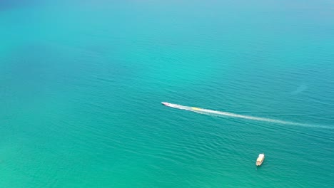 aerial-view-of-a-single-lonely-banana-boat-being-pulled-with-tourists-on-the-Mediterranean-sea-of-Turkey-on-a-hot-summer-day