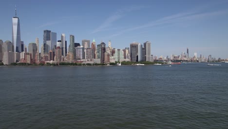 Sailboat-on-Hudson-river-with-Manhattan,-NY-skyline-background---tracking-Aerial