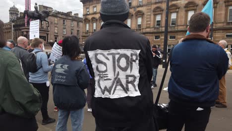A-man-has-a-'Stop-the-War'-sign-on-his-jacket