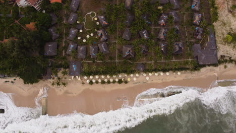 Aerial-top-down,-geotube-aqua-sand-bags-preventing-climate-change-sea-level-rise-from-destroying-coastal-tropical-town