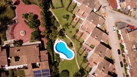 Overhead-View-Of-Holiday-Hotels-With-Swimming-Pool-On-A-Sunny-Summer-Day-In-Estepona,-Costa-del-Sol,-Spain