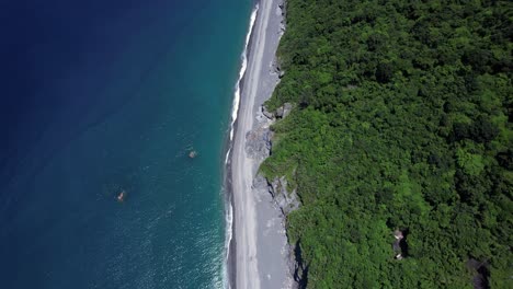 Tropical-beach-covered-in-fallen-boulders-from-gradual-cliff-side-erosion-on-the-Eastern-coast-of-Taiwan---Gradual-Gimbal-tilt-up