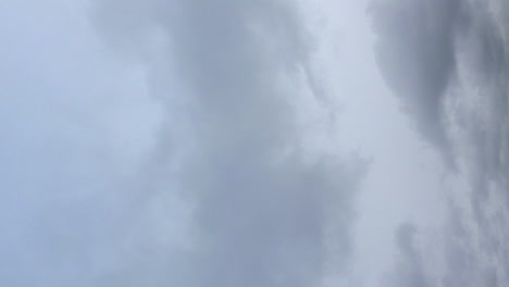 Vertical-format:-Dark-heavy-overcast-clouds-in-grey-sky-time-lapse