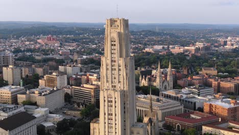 A-cinematic-orbiting-aerial-establishing-shot-of-Pitt-campus'-Cathedral-of-Learning-in-Pittsburgh's-Oakland-district-in-late-summer