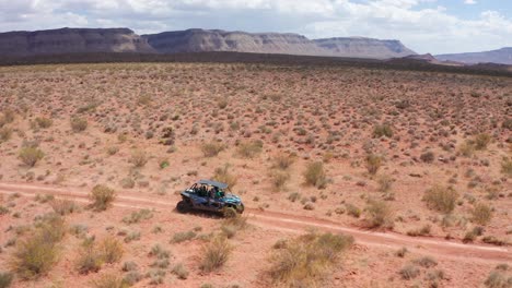 Shot-of-dune-buggy-driving-through-Utah's-desert-wasteland