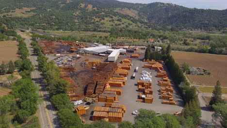 Aerial-view-across-Mendocino-timber-yard-industry-in-lush-California-mountains