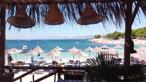 Fly-through-Tropical-Beachclub-to-Popular-Beach-in-Ksamil,-Albania