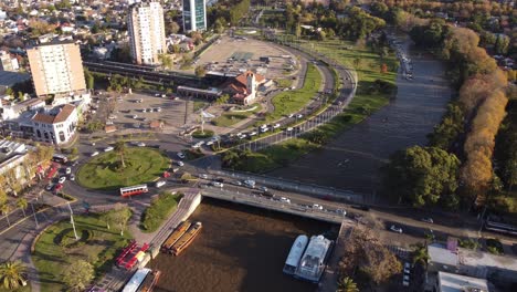 Car-Traffic-Circling-At-Tigre-City-River-Bridge-Roundabout,-Aerial