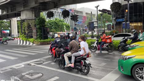 Motorbikes-waiting-for-green-traffic-light-at-junction-downtown-Bangkok
