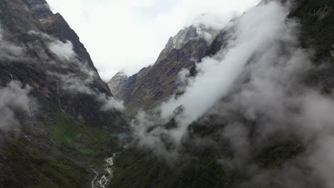 Aerial-drone-shot-of-clouds-on-the-side-of-the-Annapurna-mountains,-Nepal