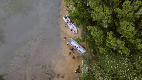 Overhead-Shot-Of-People-Removing-Their-Stuff-From-Inflatable-Boats-Going-For-Camping,-California