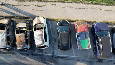 Burned-cars-in-a-parking,-aerial-overhead-view