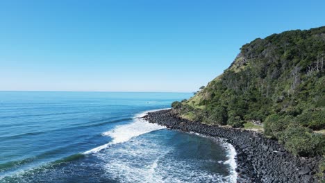 Waves-roll-in-on-the-world-famous-Burleigh-Heads-surf-break-and-iconic-headland
