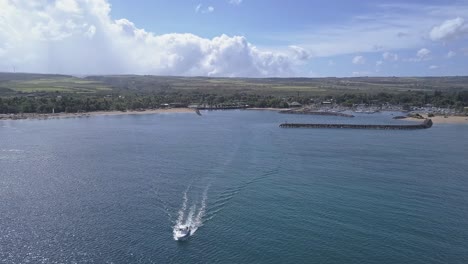 Aerial-view-of-boat-departing-Waialua-bay-in-Haleiwa-on-a-sunny-day