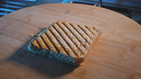 Placing-Toasted-Whole-Grain-Bread-On-Wooden-Board