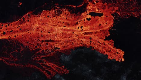Fiery-red-burning-lava-on-earth-surface,-effusive-eruption,-top-down