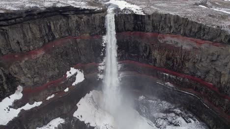 Water-crashes-down-from-Hengifoss-falls-into-the-frozen-basaltic-ravine-below