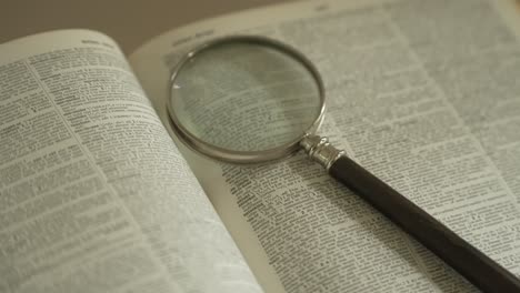Magnifying-glass-on-large-opened-book
