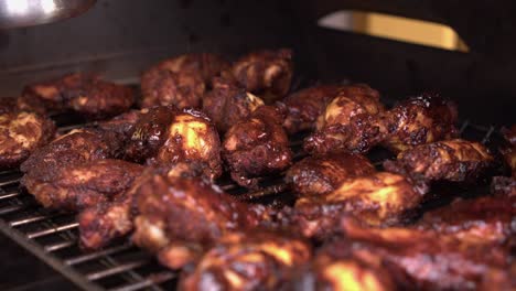 Close-up:-BBQ-sauce-brushed-onto-grilling-chicken-wings-and-drumsticks