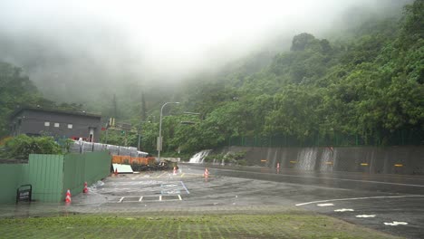 Car-entering-the-famous-Hsuehshan-Tunnel-during-bad-weather-condition-with-typhoon-approaching,-overflowing-rainwater-and-thick-fog-caused-difficult-driving-visibility-at-Hualien-city,-Taiwan